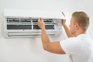 Technician installing a residential air conditioning unit in Fort Lauderdale