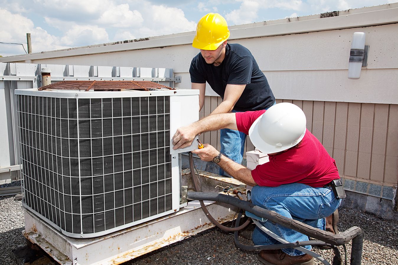 Two techs performing an HVAC Service in Delray Beach 