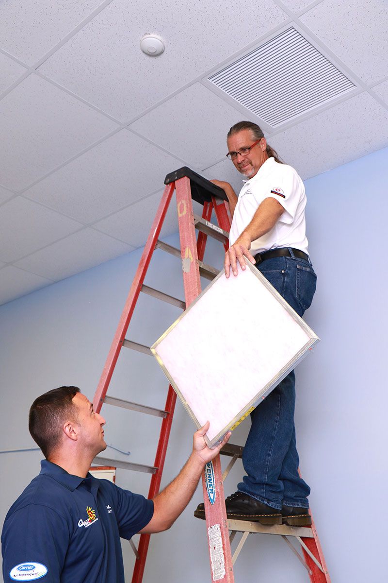 Two technicians repairing a Commercial Air Conditioning Filter in Margate.