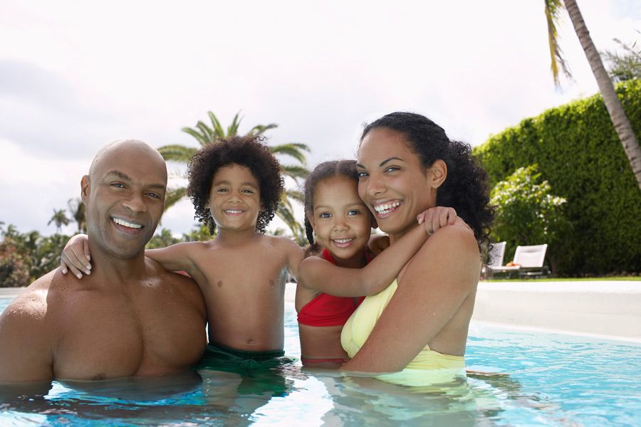 family-enjoying-swimming-pool-in-fall-and-winter-fl pool heater for swimming in Florida winter