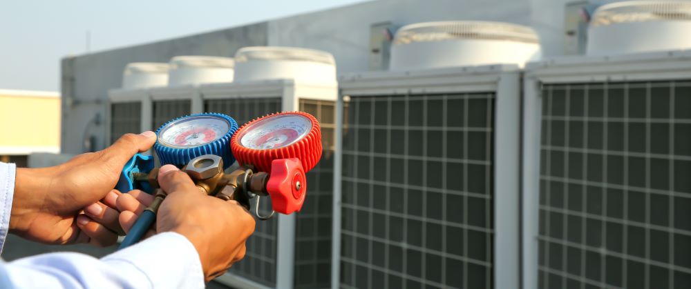 Tech working on hvac units outside lined up